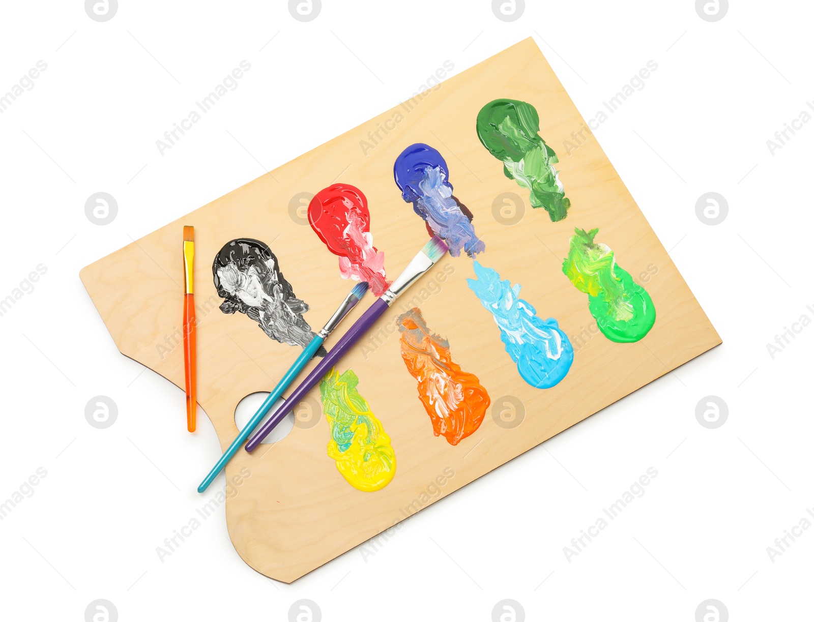 Wooden palette with paints and brushes isolated on white, top view Photo of Wooden palette with paints and brushes isolated on white, top view