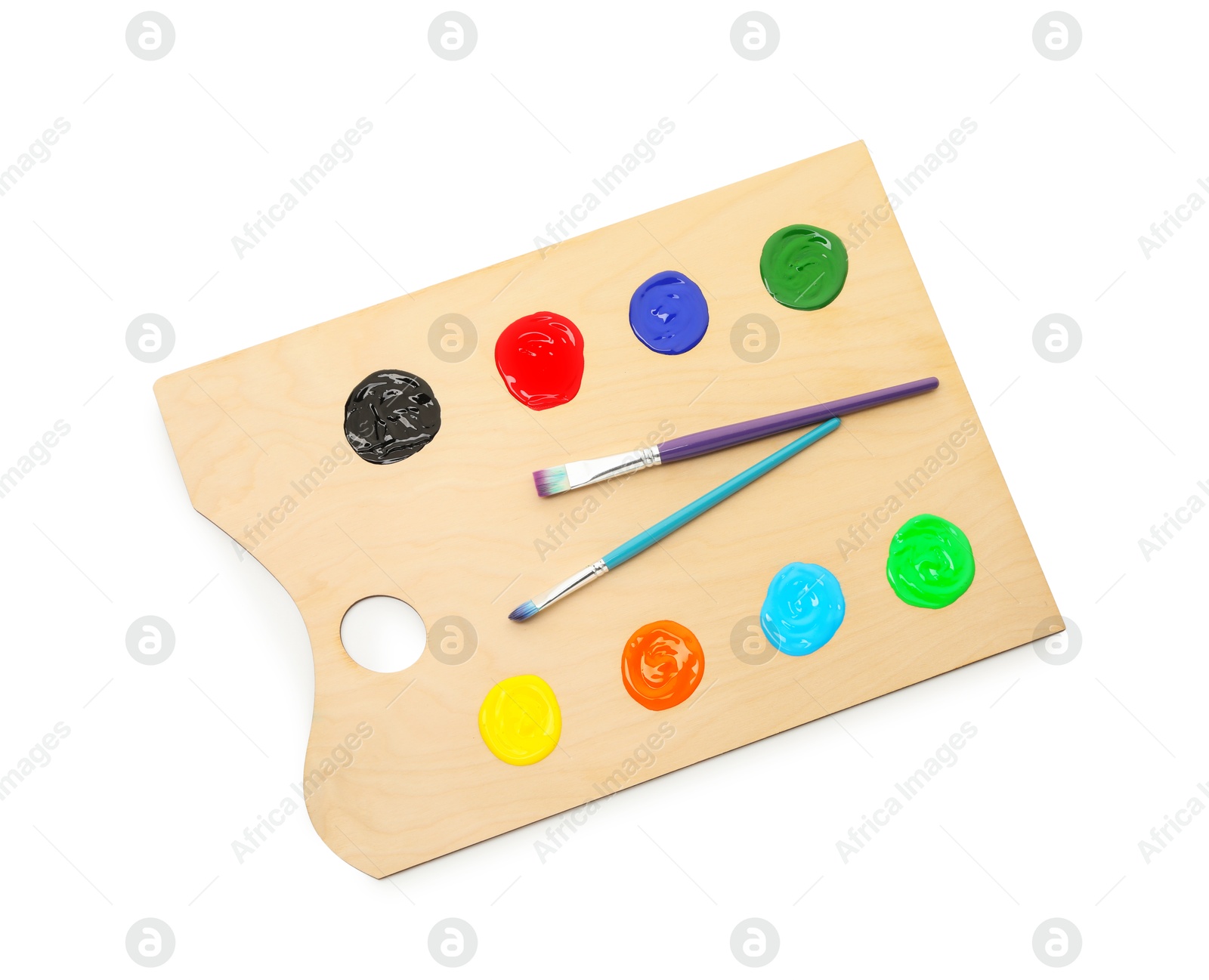 Wooden palette with paints and brushes isolated on white, top view Photo of Wooden palette with paints and brushes isolated on white, top view