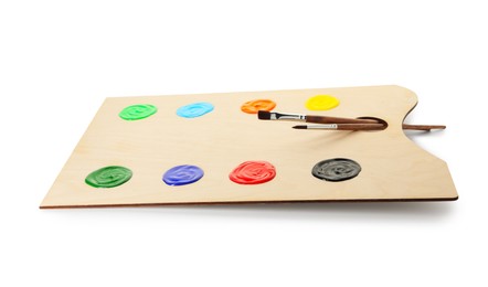 Photo of Wooden palette with paints and brushes isolated on white