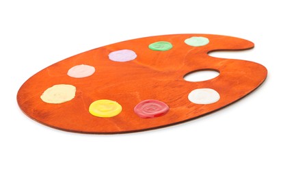 Photo of Wooden palette with paints isolated on white