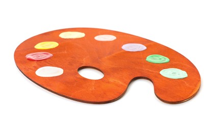 Photo of Wooden palette with paints isolated on white