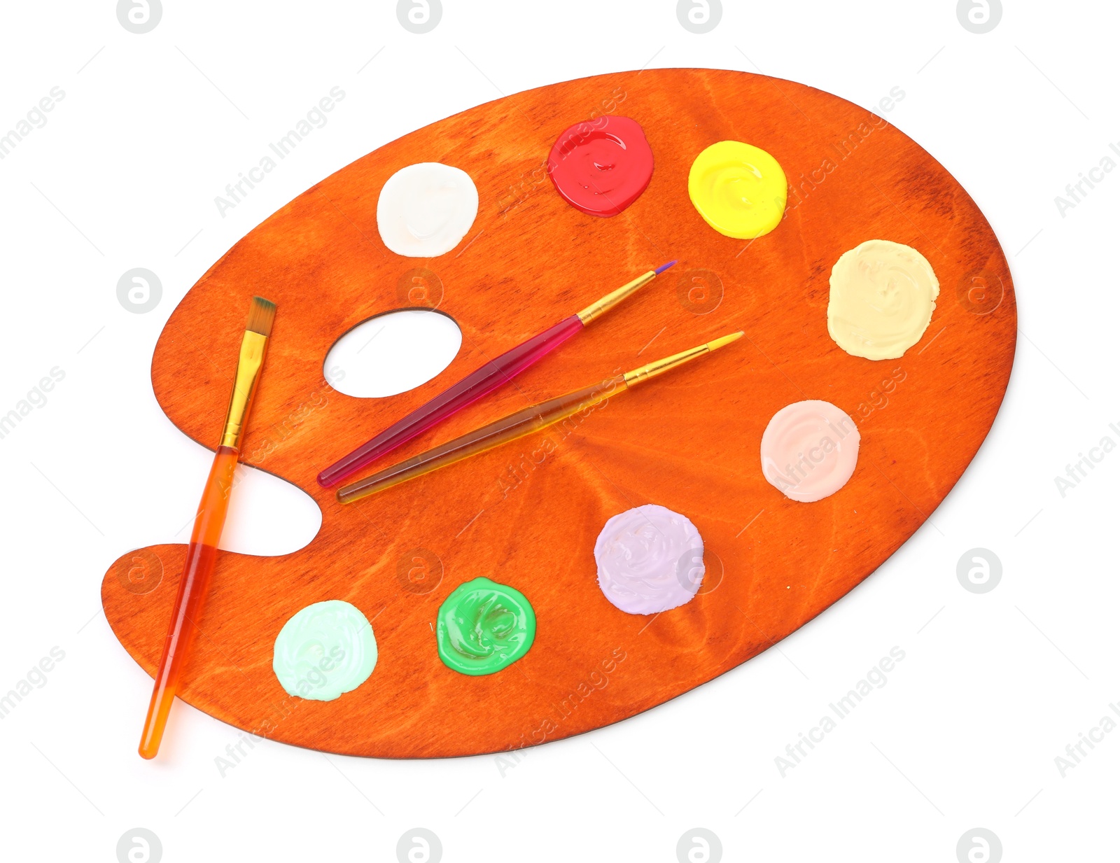 Wooden palette with paints and brushes isolated on white, top view Photo of Wooden palette with paints and brushes isolated on white, top view