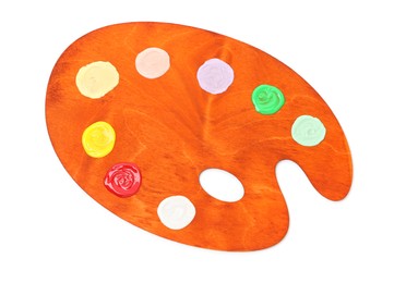 Photo of Wooden palette with paints isolated on white, top view