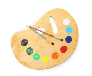 Photo of Wooden palette with paints and brushes isolated on white, top view