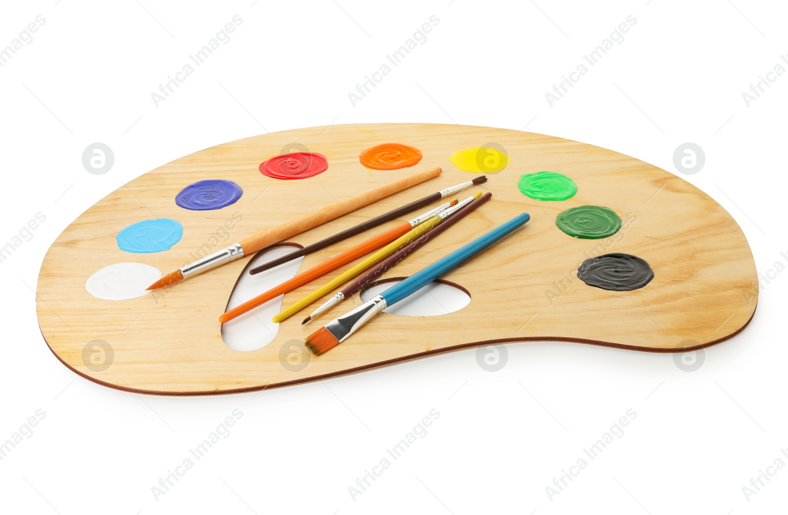 Photo of Wooden palette with paints and brushes isolated on white