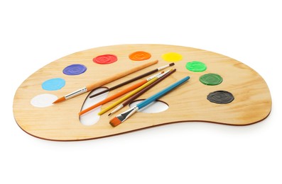 Photo of Wooden palette with paints and brushes isolated on white