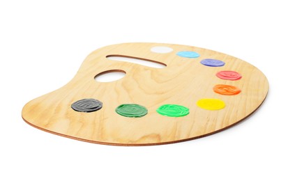 Photo of Wooden palette with paints isolated on white