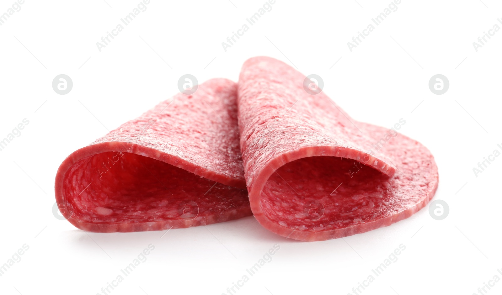 Slices of tasty smoked sausage isolated on white Photo of Slices of tasty smoked sausage isolated on white