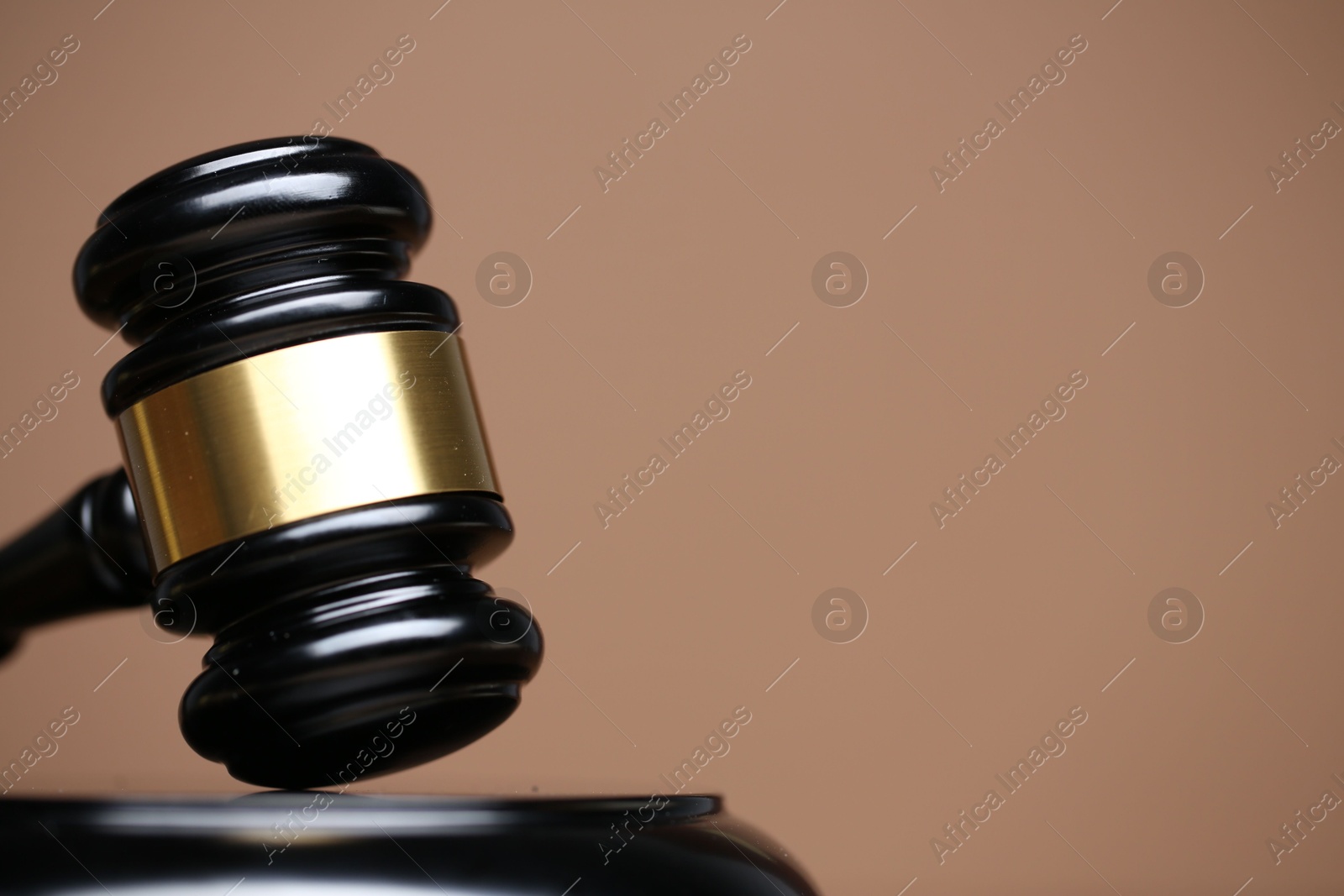 Judge's gavel and sound block on pale brown background, closeup. Space for text Photo of Judge's gavel and sound block on pale brown background, closeup. Space for text