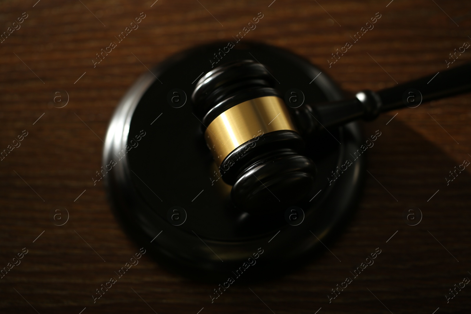 Judge's gavel and sound block on wooden table, above view Photo of Judge's gavel and sound block on wooden table, above view