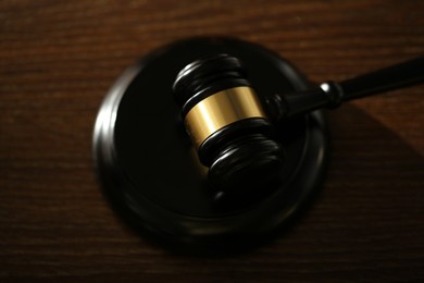 Photo of Judge's gavel and sound block on wooden table, above view