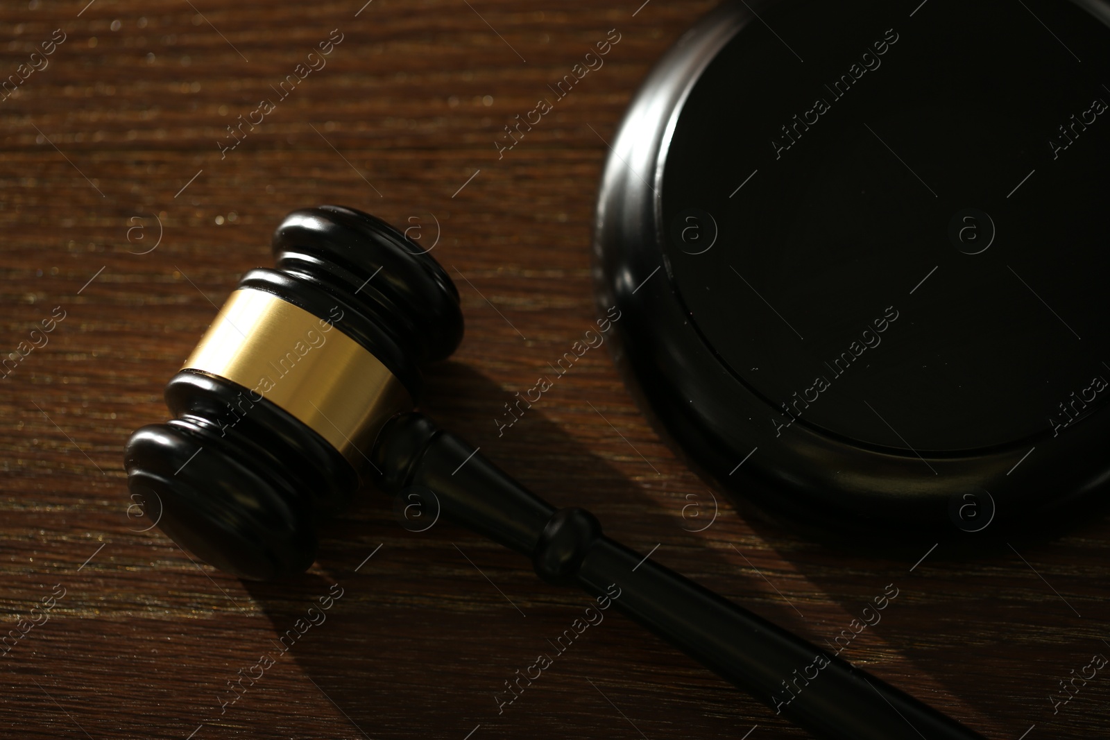 Judge's gavel and sound block on wooden table, above view Photo of Judge's gavel and sound block on wooden table, above view