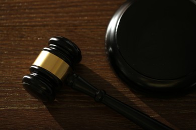 Photo of Judge's gavel and sound block on wooden table, above view