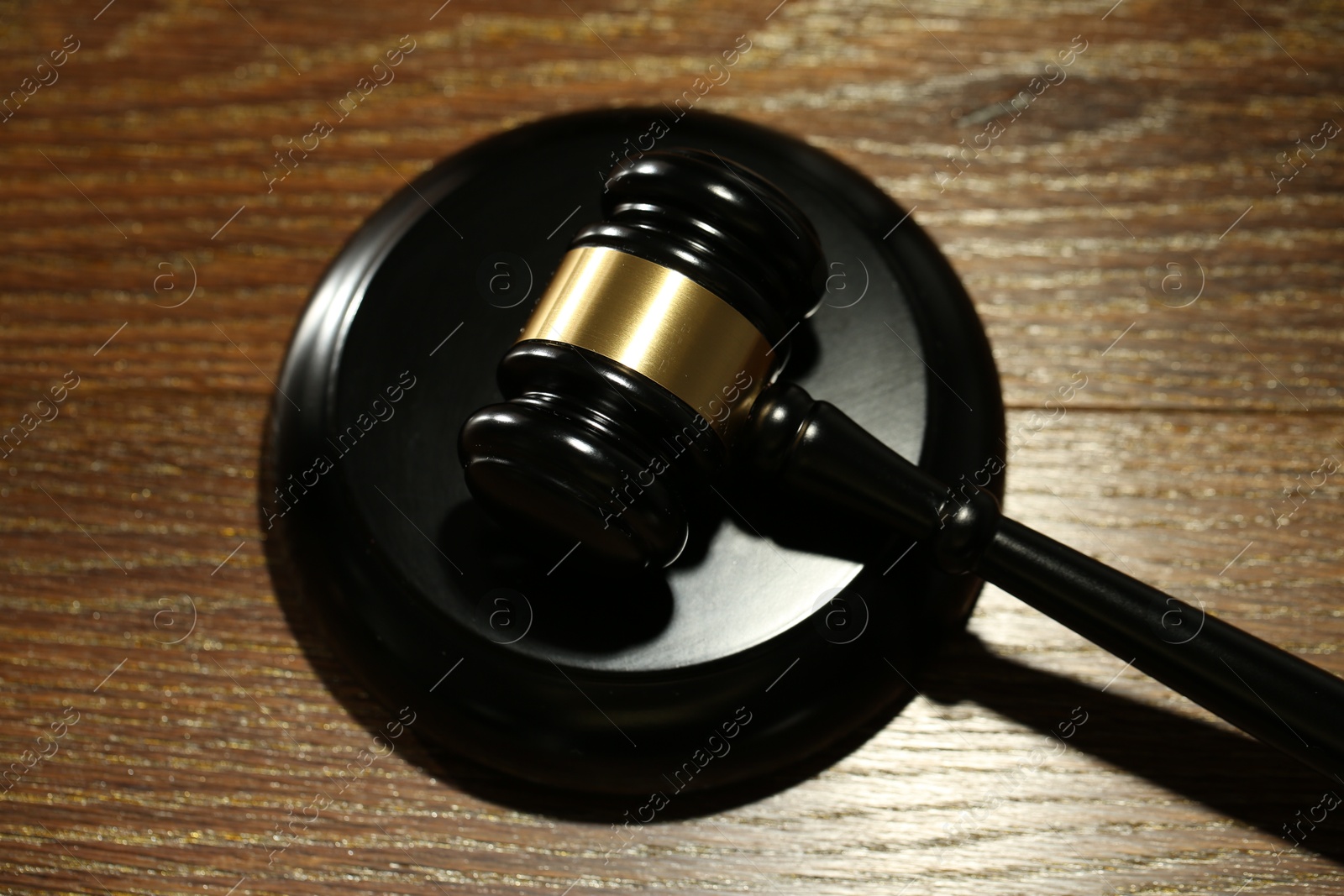 Judge's gavel and sound block on wooden table, above view Photo of Judge's gavel and sound block on wooden table, above view