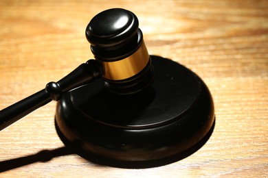 Photo of Judge's gavel and sound block on wooden table, closeup