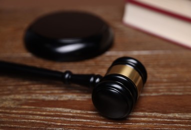 Photo of Judge's gavel and sound block on wooden table, closeup