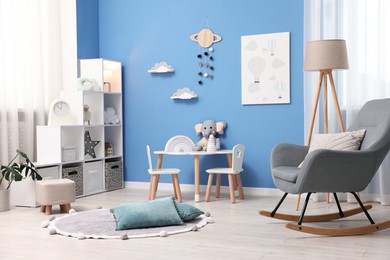 Photo of Child's room with stylish furniture and toys. Interior design
