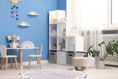 Photo of Child's room with stylish furniture and toys. Interior design