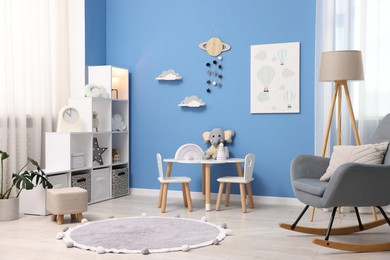 Photo of Child's room with stylish furniture and toys. Interior design