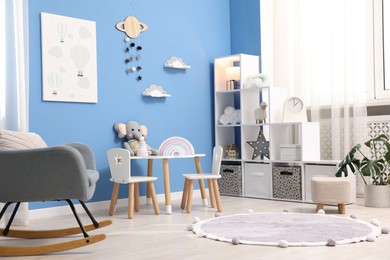 Photo of Child's room with stylish furniture and toys. Interior design