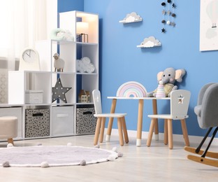 Photo of Child's room with stylish furniture and toys. Interior design