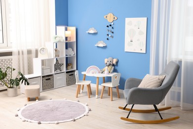 Photo of Child's room with stylish furniture and toys. Interior design