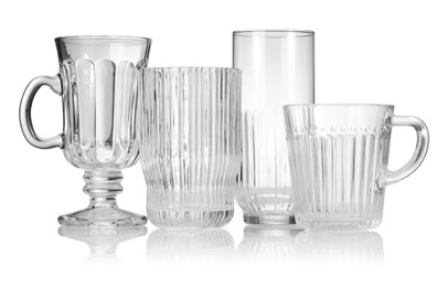 Photo of Different empty clean glasses isolated on white