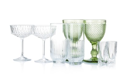 Photo of Different empty clean glasses isolated on white