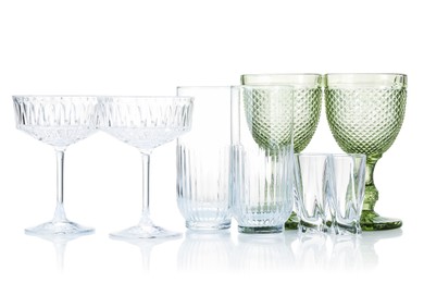 Photo of Different empty clean glasses isolated on white