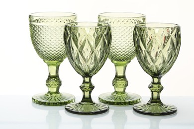 Photo of Different empty clean glasses isolated on white