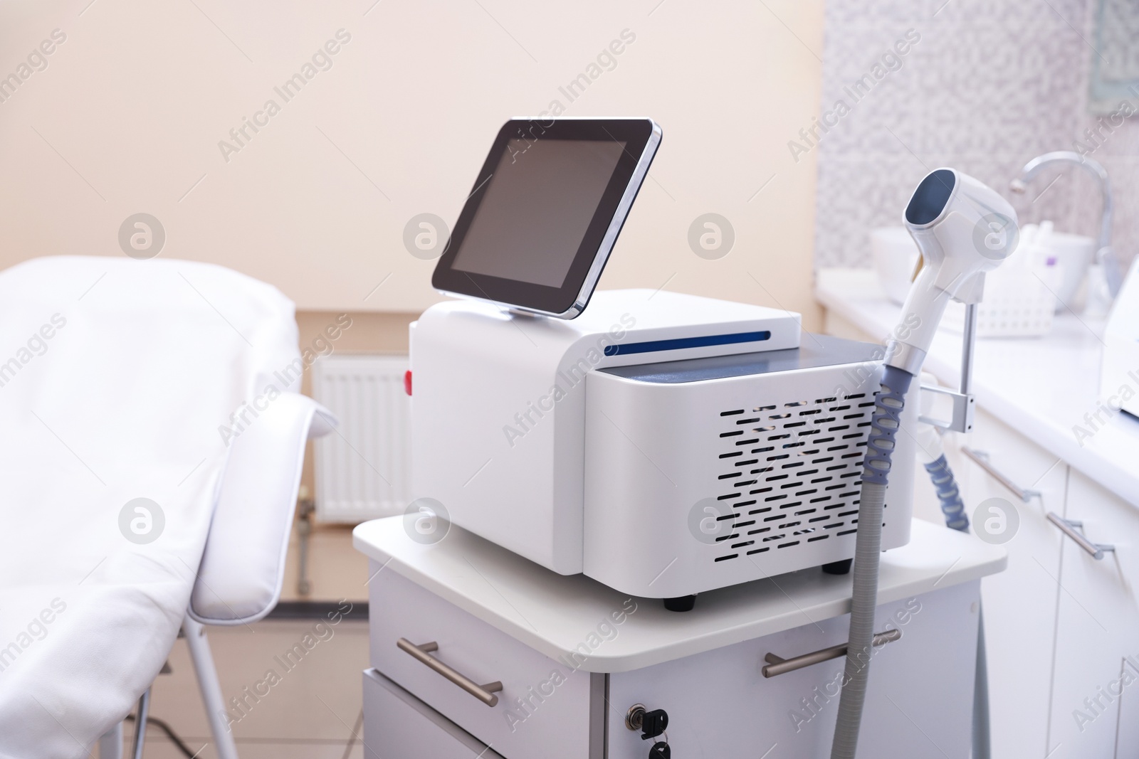 Laser hair removal machine and medical couch in beauty salon Photo of Laser hair removal machine and medical couch in beauty salon