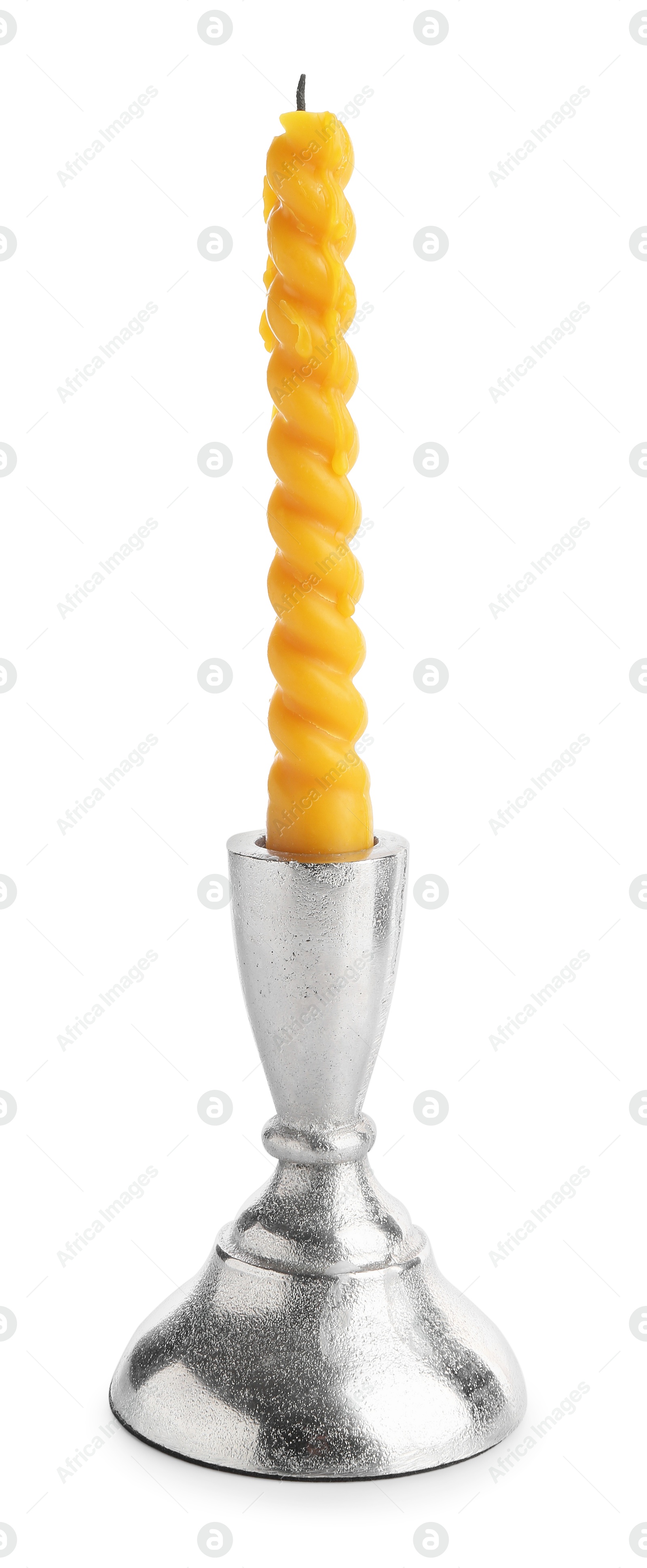 Beeswax candle in candlestick isolated on white Photo of Beeswax candle in candlestick isolated on white