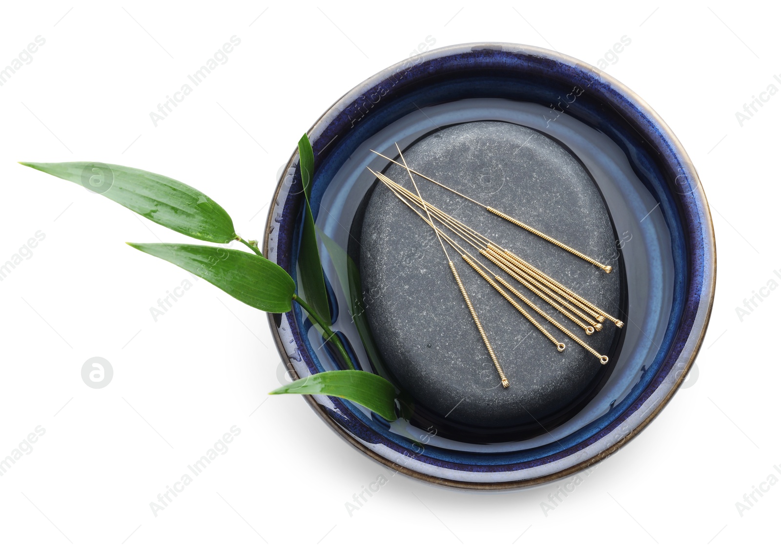 Acupuncture needles, spa stone and leaves isolated on white, top view Photo of Acupuncture needles, spa stone and leaves isolated on white, top view