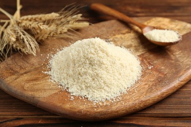 Photo of Pile of flour and spikes on wooden table, closeup