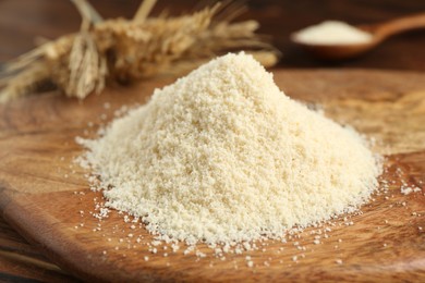 Photo of Pile of flour and spikes on wooden table, closeup