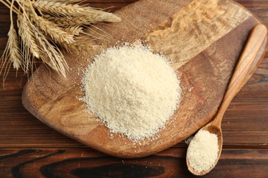 Photo of Pile of flour and spikes on wooden table, flat lay