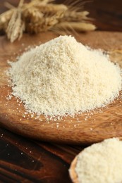 Photo of Pile of flour and spikes on wooden table, closeup