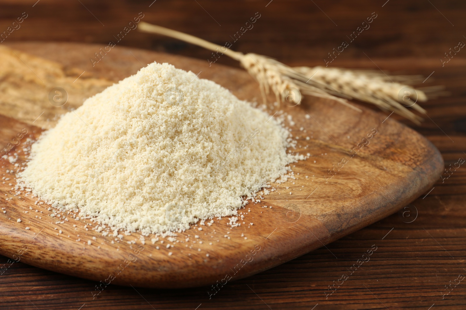 Pile of flour and spikes on wooden table, closeup Photo of Pile of flour and spikes on wooden table, closeup