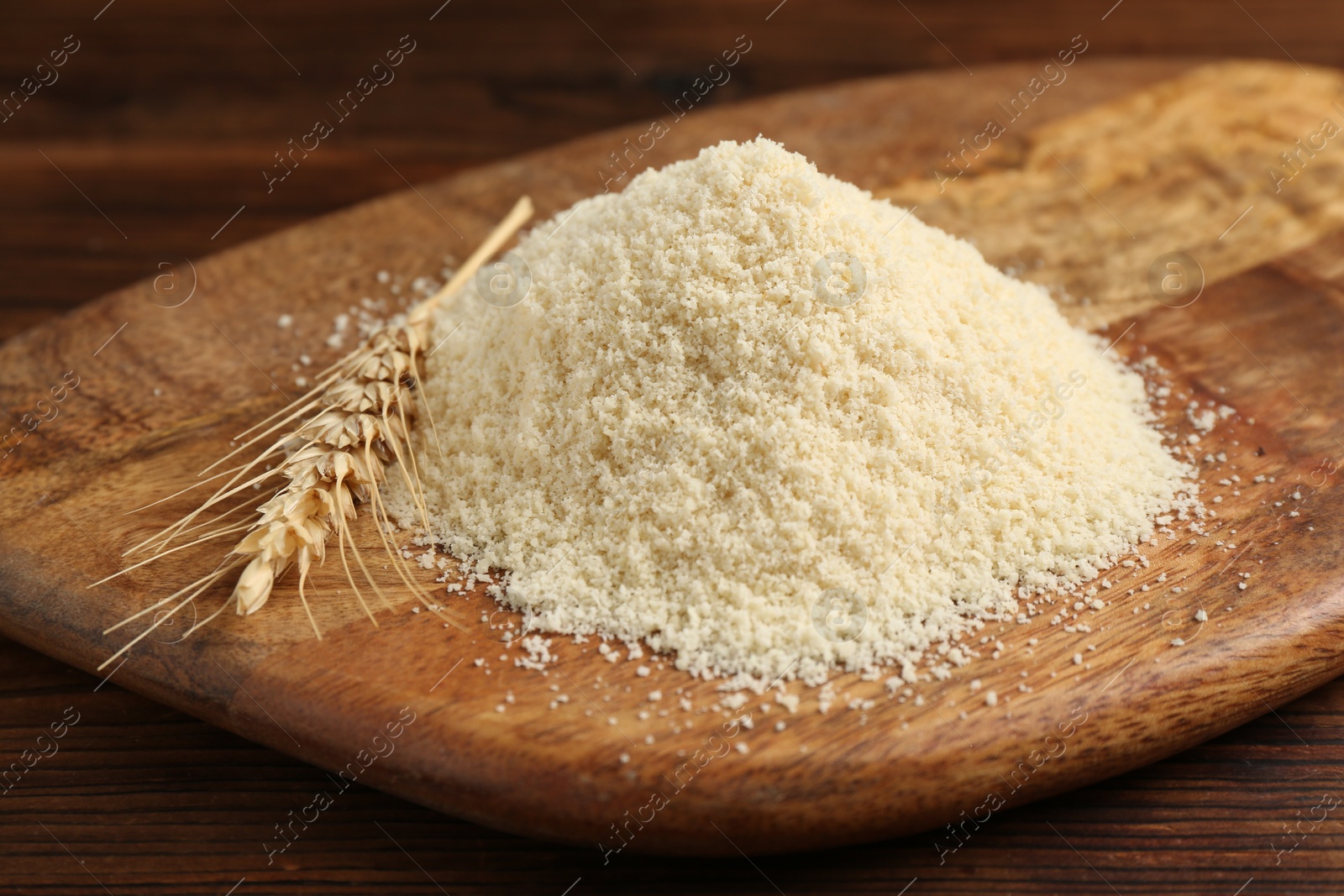 Pile of flour and spike on wooden table, closeup Photo of Pile of flour and spike on wooden table, closeup