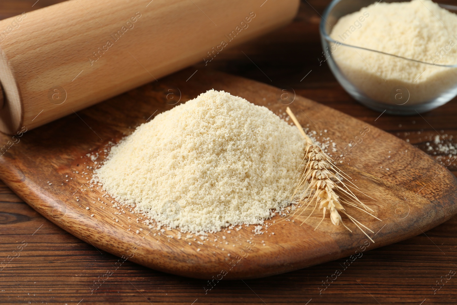 Pile of flour, spike and rolling pin on wooden table, closeup Photo of Pile of flour, spike and rolling pin on wooden table, closeup