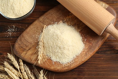 Photo of Pile of flour and spikes on wooden table, flat lay