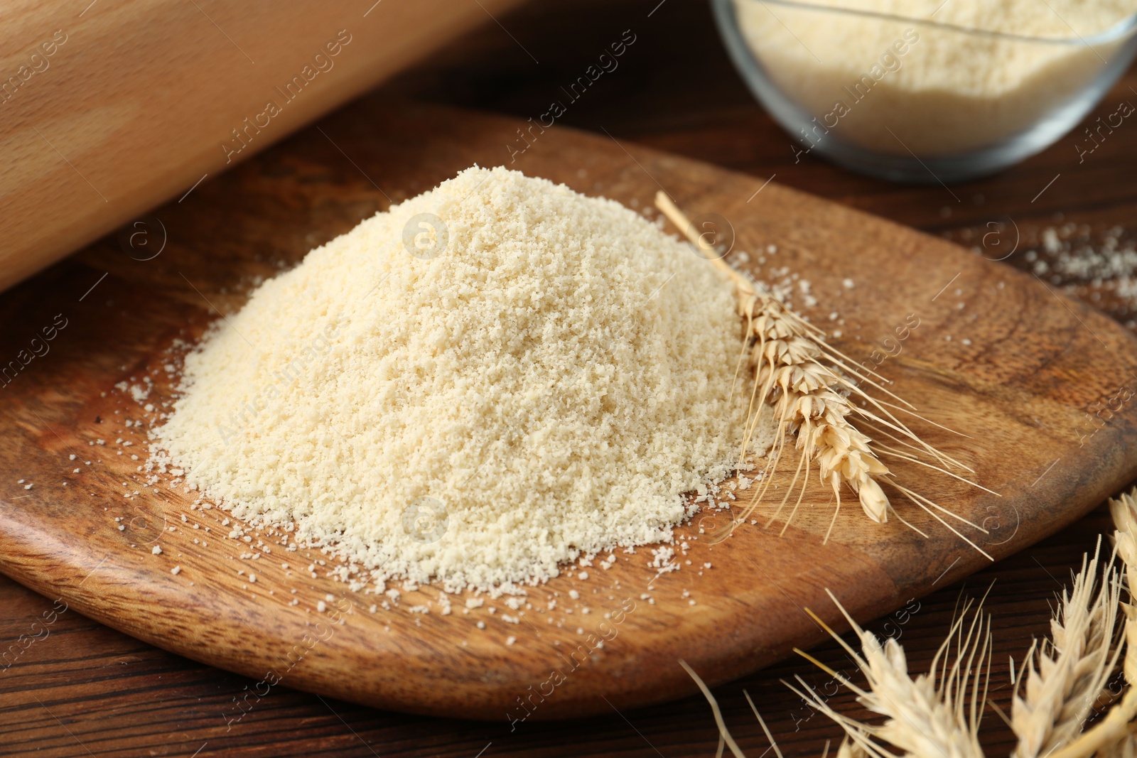 Pile of flour and spikes on wooden table, closeup Photo of Pile of flour and spikes on wooden table, closeup
