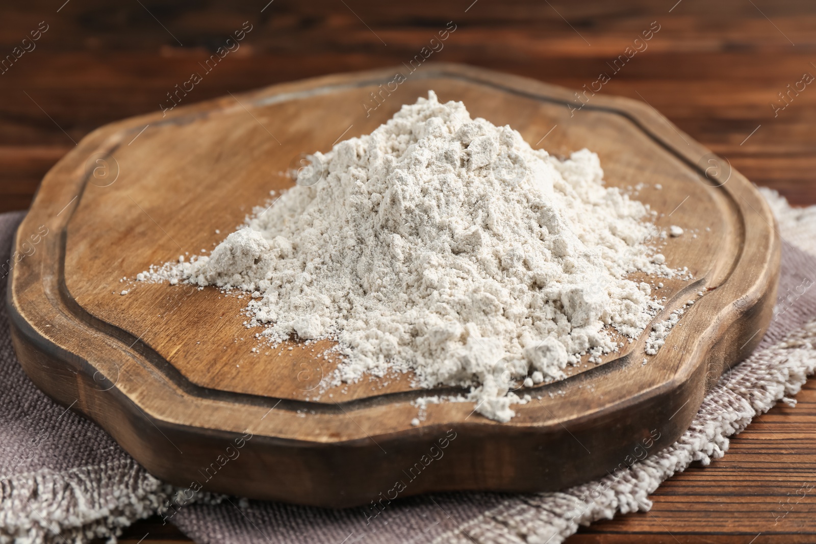 Pile of flour on wooden table, closeup Photo of Pile of flour on wooden table, closeup