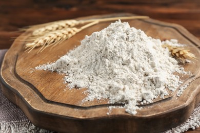 Photo of Pile of flour and spikes on wooden table, closeup