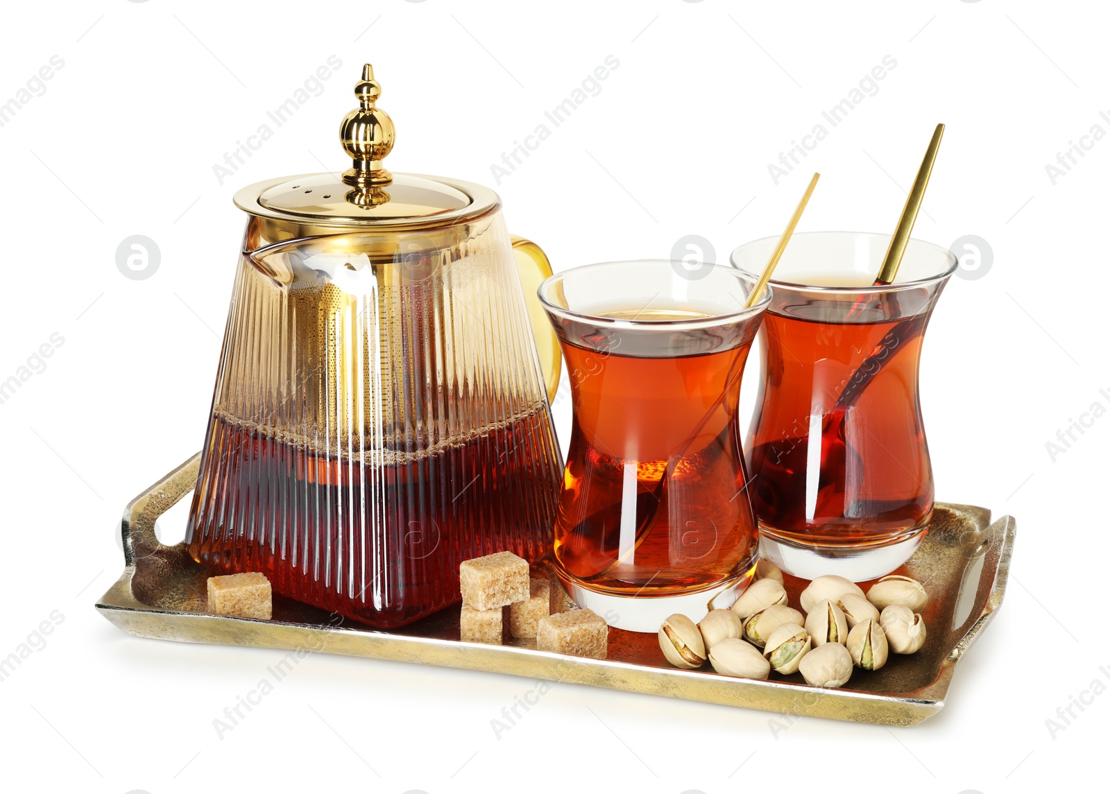 Traditional Turkish tea in glasses, teapot, brown sugar and pistachios isolated on white Photo of Traditional Turkish tea in glasses, teapot, brown sugar and pistachios isolated on white
