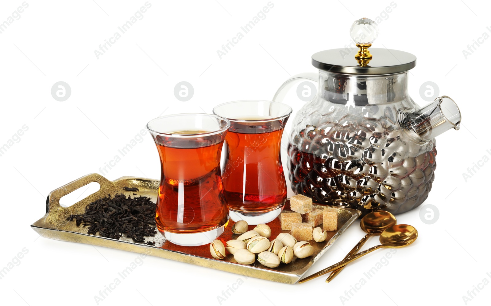 Traditional Turkish tea in glasses, teapot, brown sugar, pistachios and dry leaves isolated on white Photo of Traditional Turkish tea in glasses, teapot, brown sugar, pistachios and dry leaves isolated on white