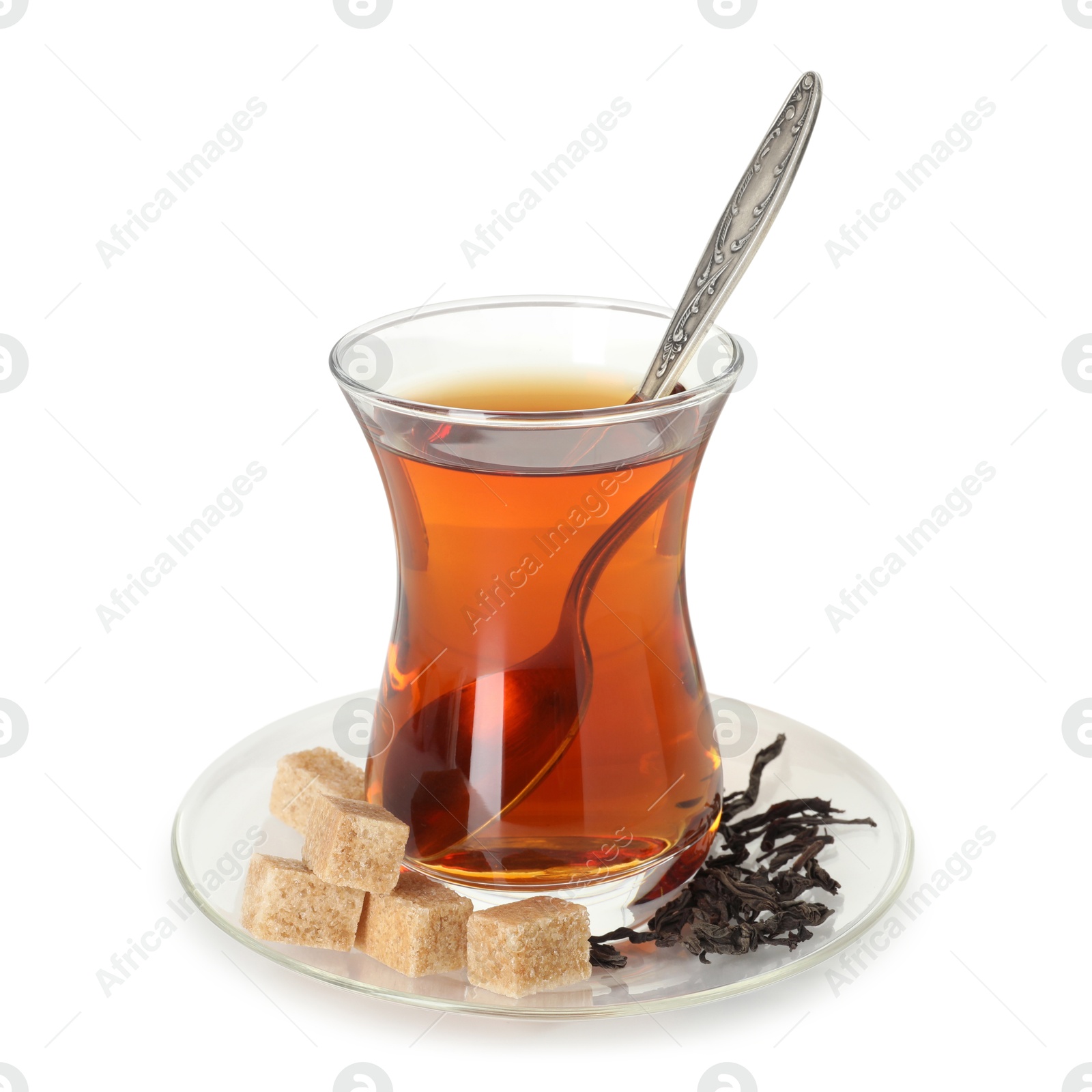 Traditional Turkish tea in glass, brown sugar and dry leaves isolated on white Photo of Traditional Turkish tea in glass, brown sugar and dry leaves isolated on white