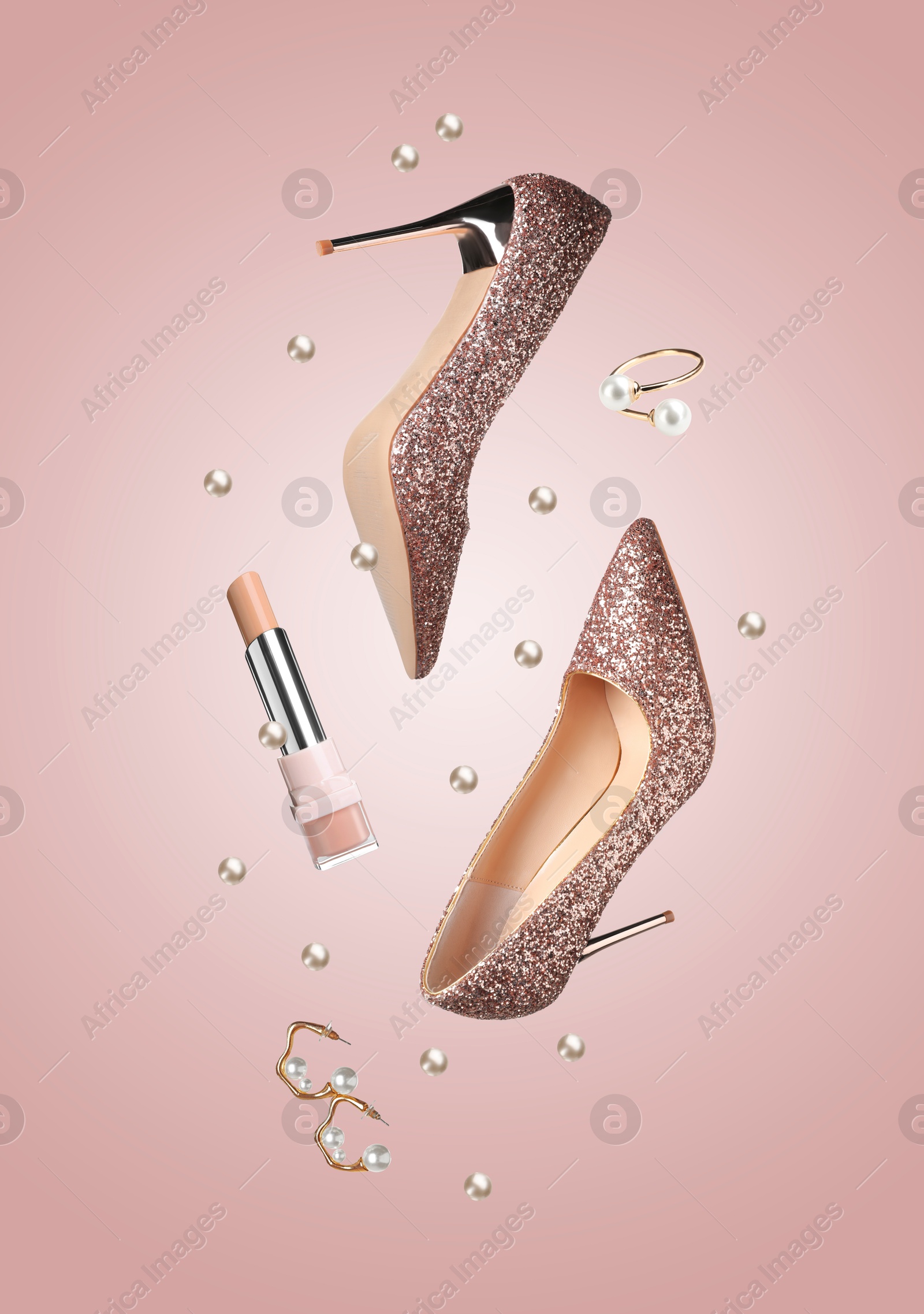 Fashionable shoes, lipstick, jewelry and pearls in air on pink background Image of Fashionable shoes, lipstick, jewelry and pearls in air on pink background