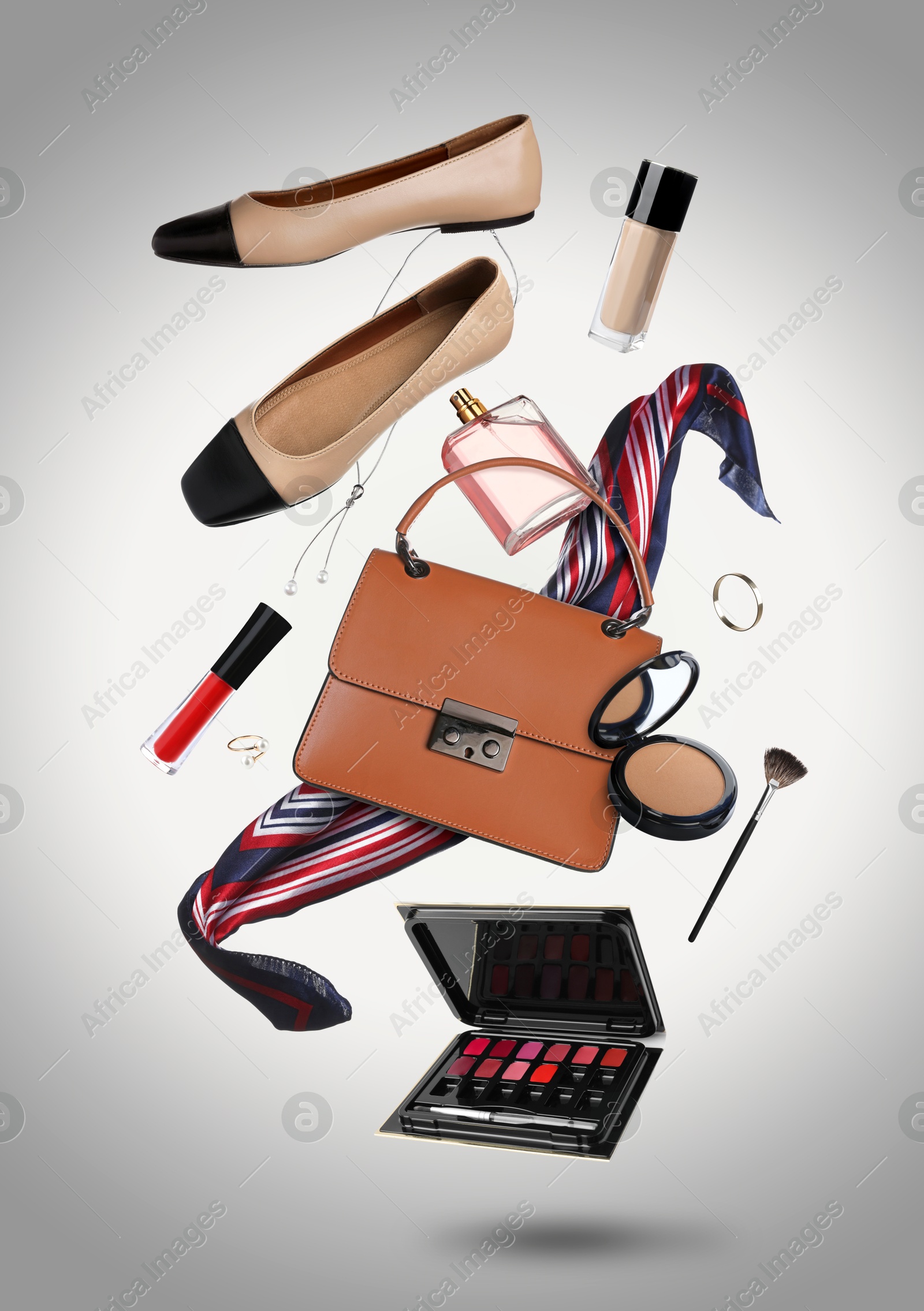 Fashionable shoes, makeup products and accessories in air on grey background Image of Fashionable shoes, makeup products and accessories in air on grey background