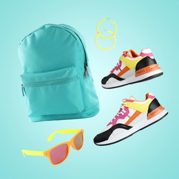 Image of Fashionable shoes and accessories in air on turquoise background